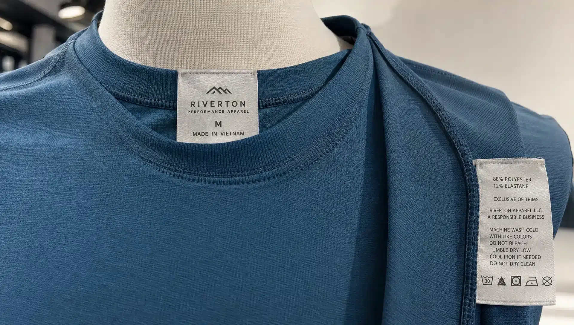 An athletic shirt carries an origin label at the neck and a side-seam label with fiber content, business identification, and care instructions.